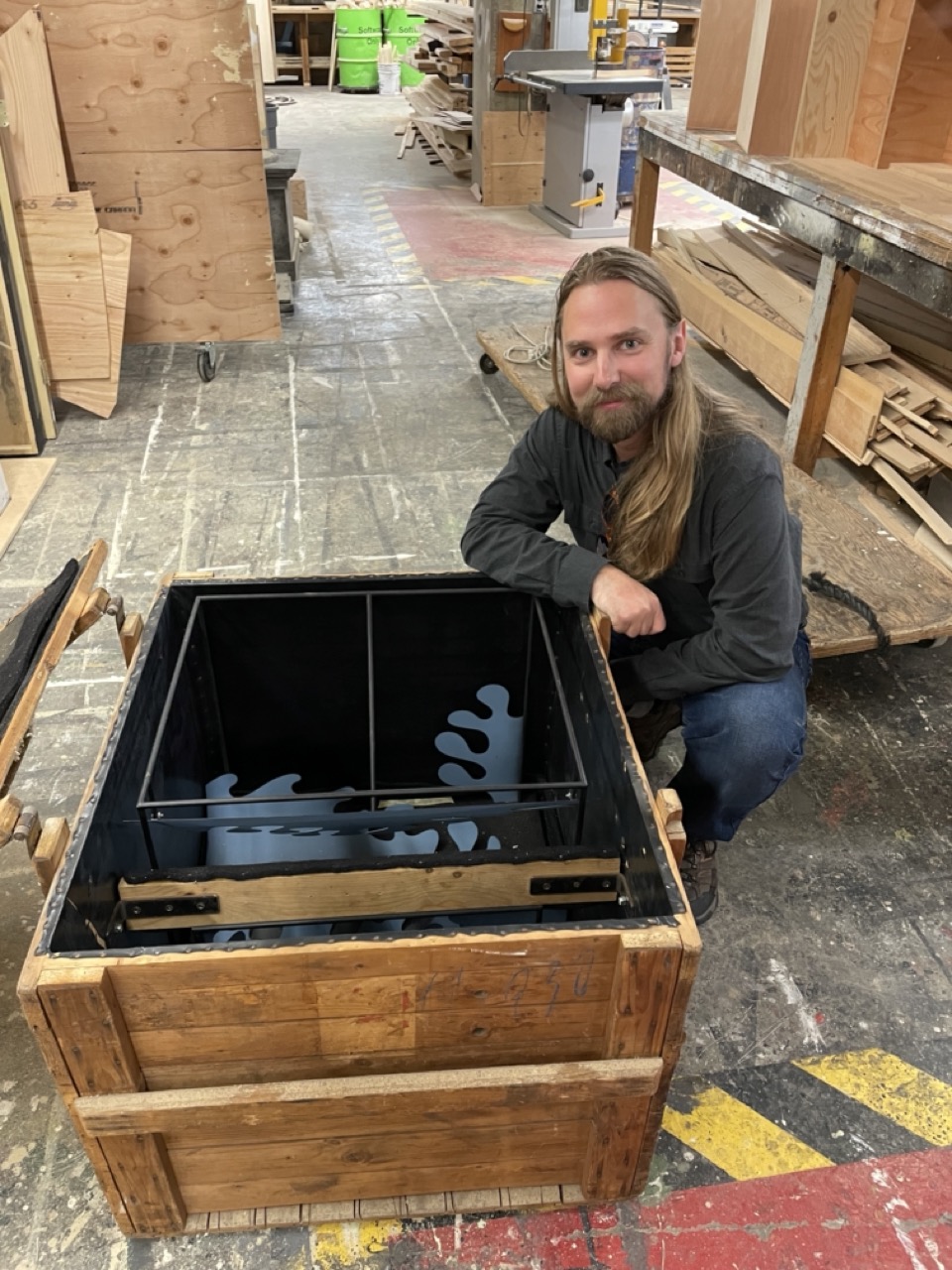 Michael smiles posing with a new technology building box 